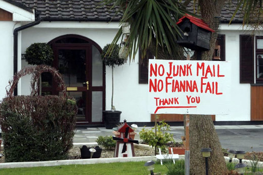 A large sign in a garden that reads 'No Junk Mail, No Fianna Fail'.